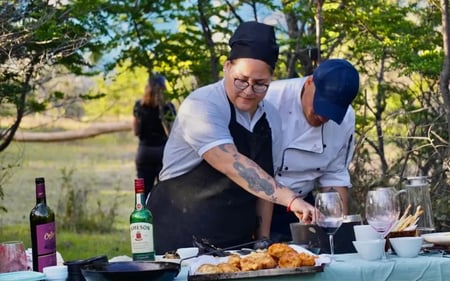 Two of the hotel cooks prepare an al fresco lunch consisting of grilled chicken.