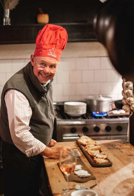 A male guest enjoys a cooking class in the estancia kitchen.