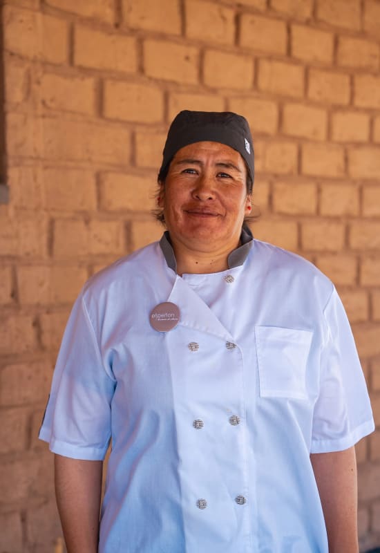 One of the hotel's chefs, Luisa, stands smiling.