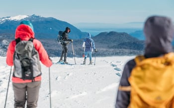 A family hike on a snow-covered mountain.