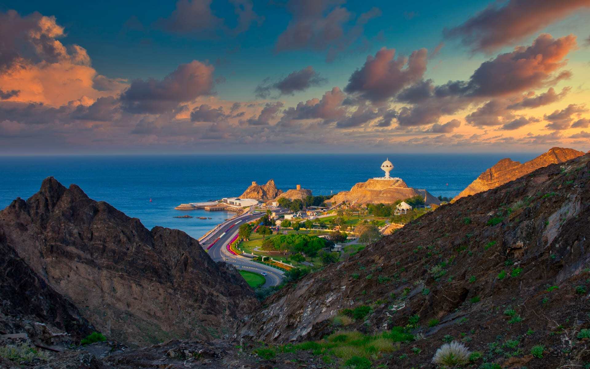 Muscat looks beautiful during a gentle sunset as it peaks through its neighbouring hills.