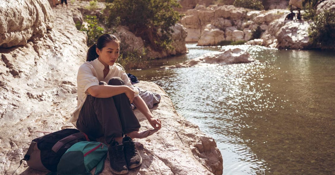 A Lady enjoys a beautiful wadi in Oman.