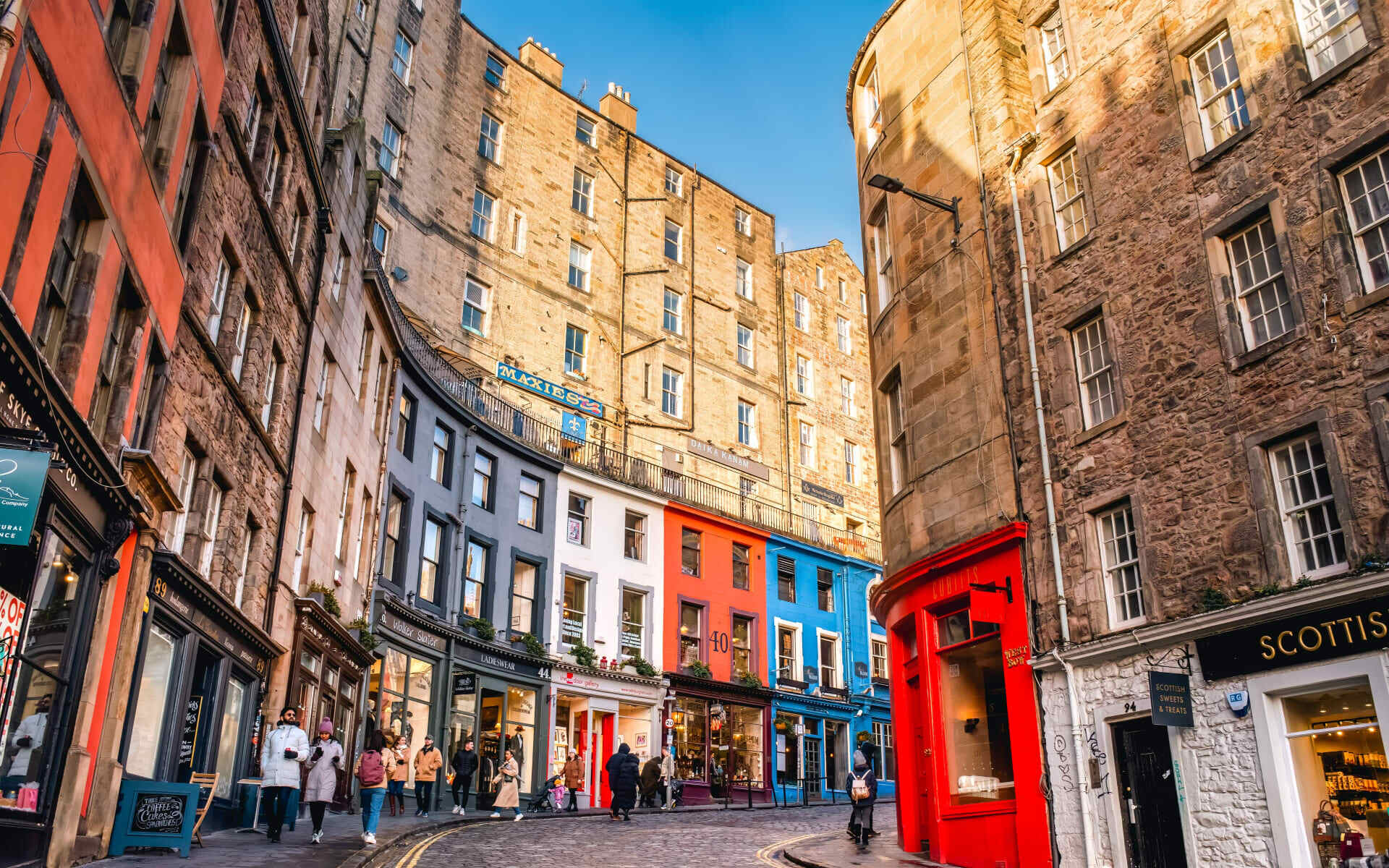 The streets of Edinburgh are lined with brightly coloured houses.