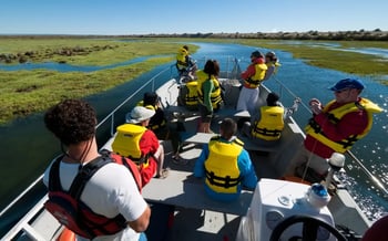 A group of guests enjoy a motorboat ride around the surrounding wetlands.