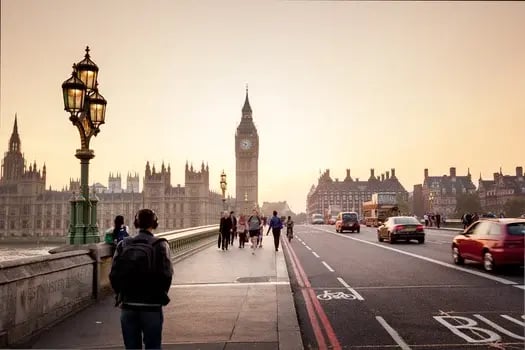 A man wanders London in England during sunset.