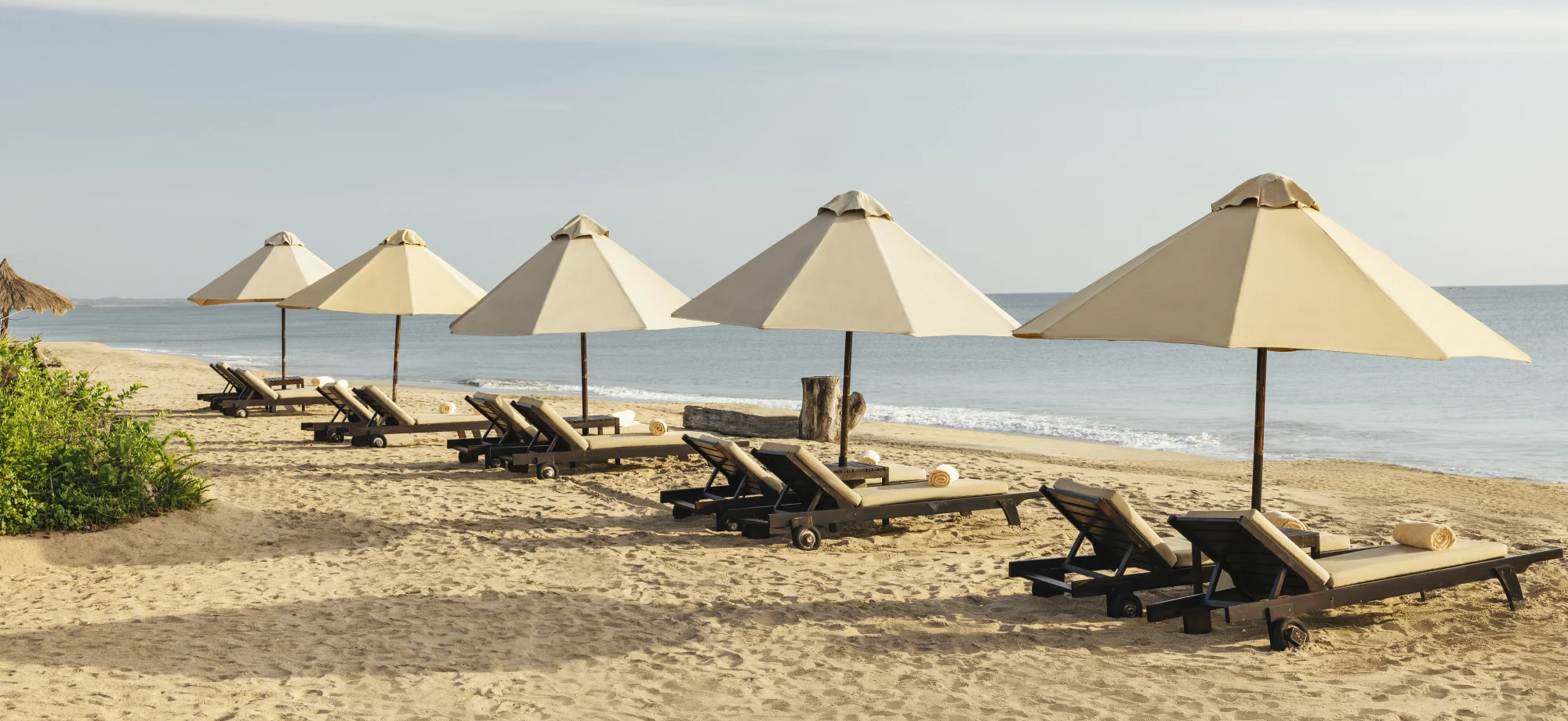 A row of sun loungers face the vast Indian Ocean.