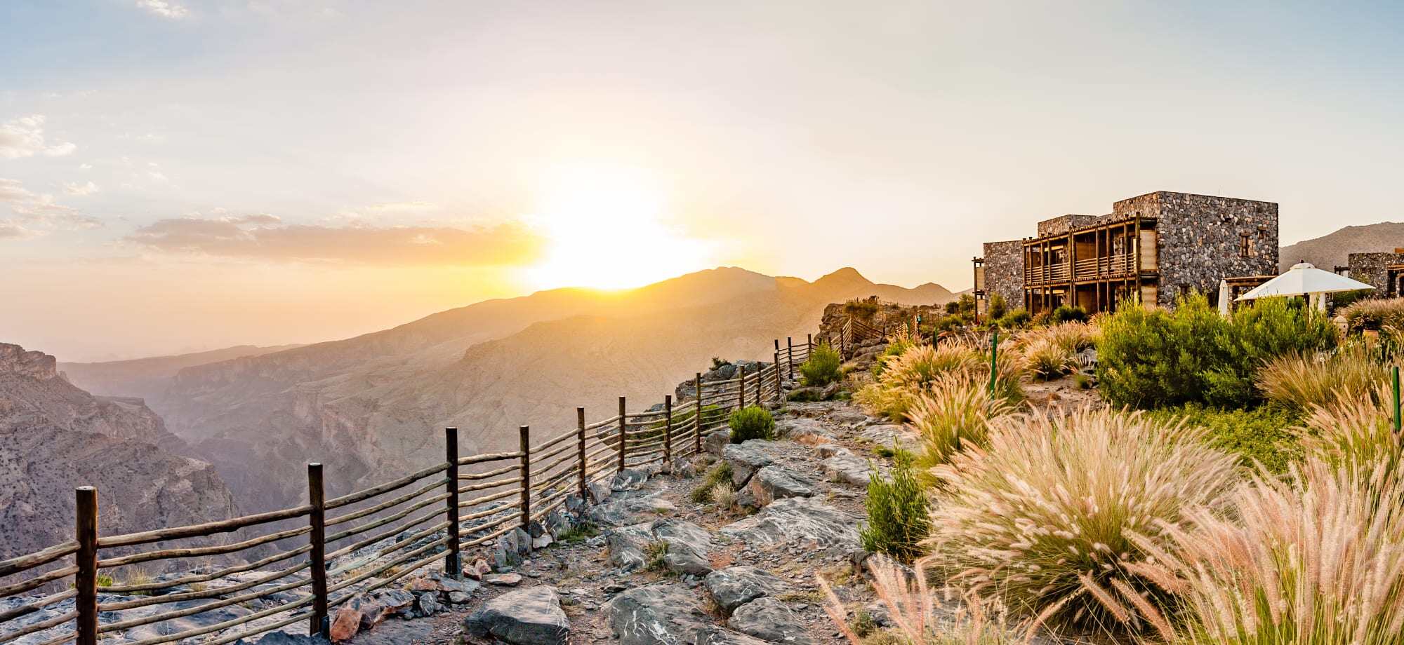 A viewpoint on the Omani Mountain overlooks a sunrise.