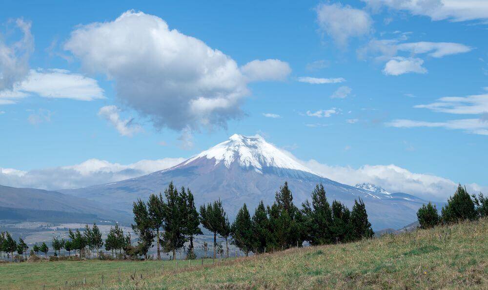 snow-capped mountain overlooking farmlands in ecuador