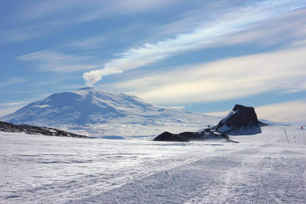 mount erebus volcano steaming and covered in snow
