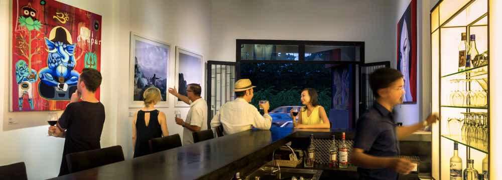 Guests enjoy an exhibition at the One Eleven Gallery in Siem Reap