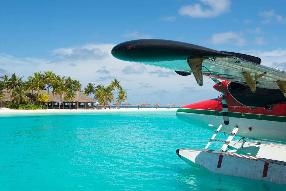 seaplane landing on the bright blue waters of the maldives